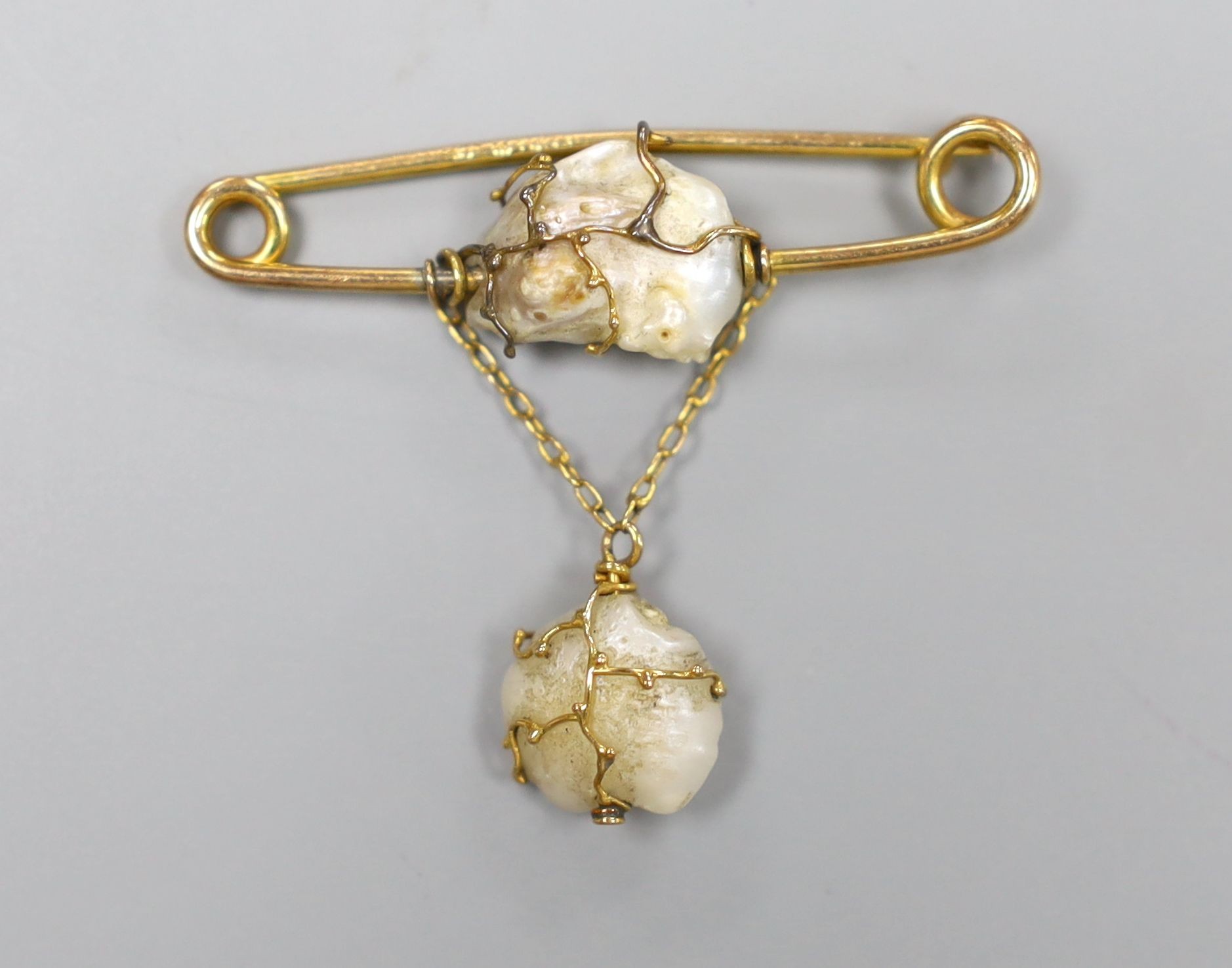 An early 20th century 9ct and two stone baroque pearl set drop brooch by Murrle Bennett & Co, width 4cm, gross 3.4 grams.